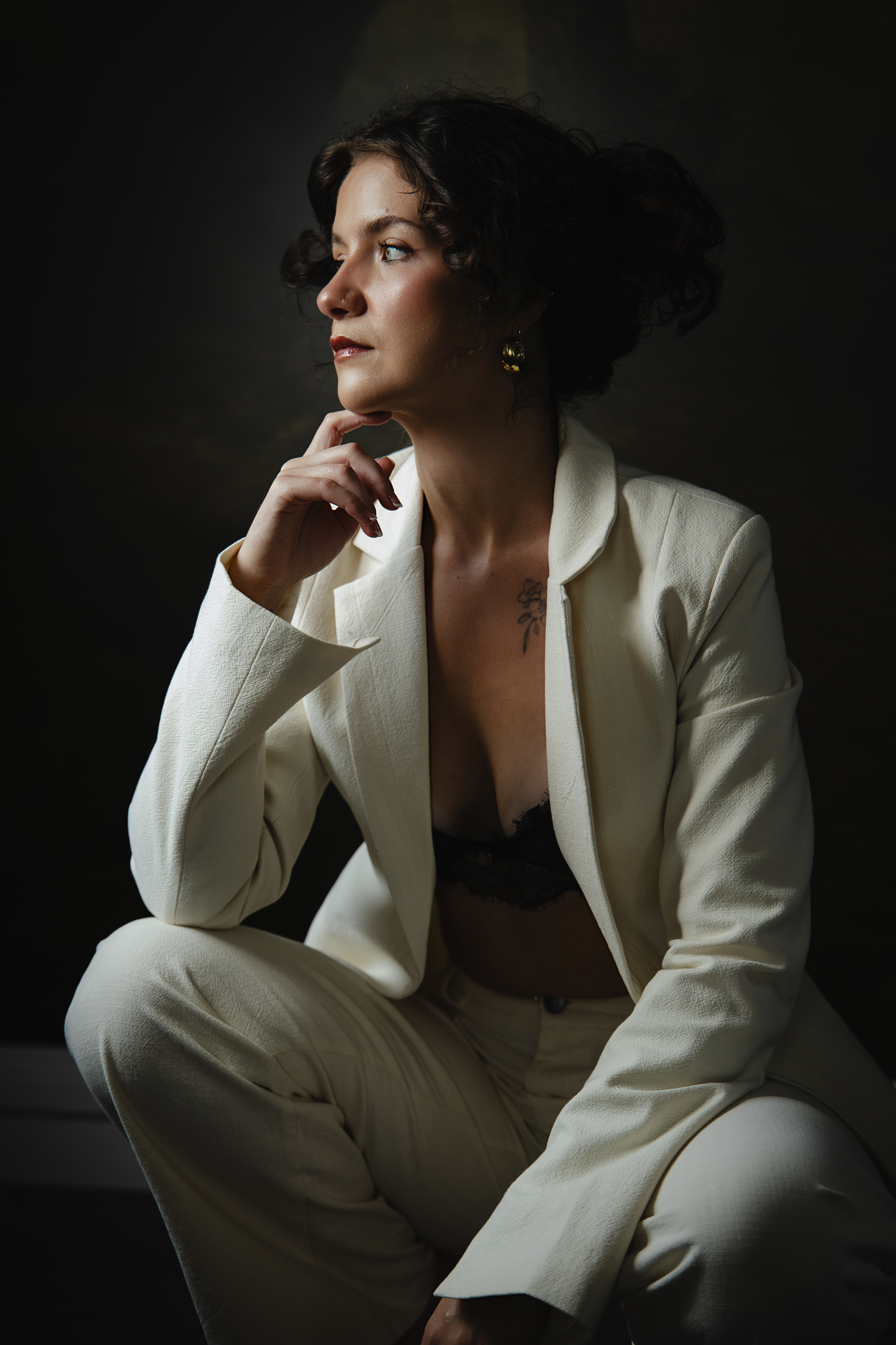A portrait of me, Jess, wearing a white blazer in my studio